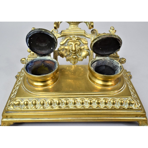 12 - A French Brass Desktop Penrest and Two Bottle Inkstand on Four Claw Feet, 24cm Wide