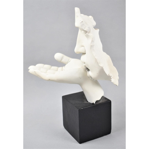 89 - A Modern Cast Resin Study of Face Blowing a Kiss, 26cm high