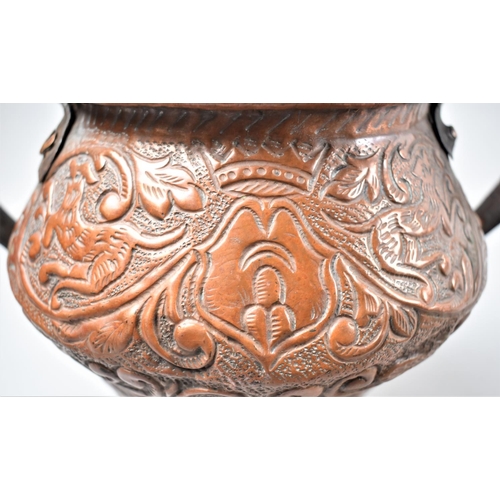 102 - An Interesting Hand Crafted Copper Vase with Twin Iron Handles and Decorated In Relief with Lions an... 