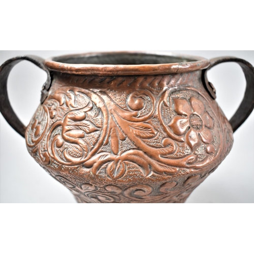 102 - An Interesting Hand Crafted Copper Vase with Twin Iron Handles and Decorated In Relief with Lions an... 