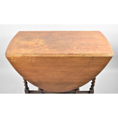 148 - An Oak Barley Twist Drop Leaf Oval Topped Gate Legged Table, 99cm Long