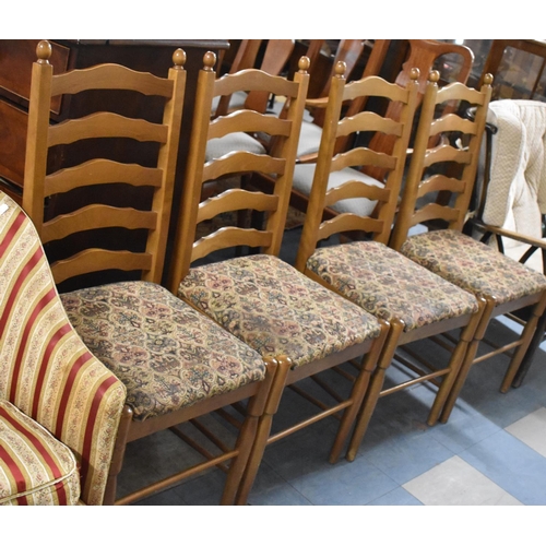 575 - A Set of Four Upholstered Ladder Back Dining Chairs