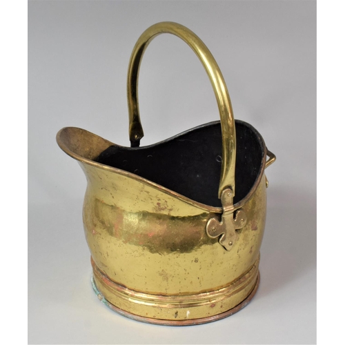 66 - A Brass Helmet Shaped Coal Scuttle with Loop Handle, 38cm high