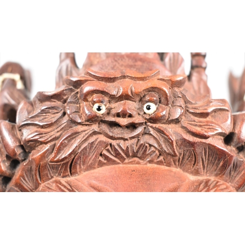 103 - A Far Eastern Carved Wooden Mask Depicting Warrior God with Dragons on Head, 23cm high