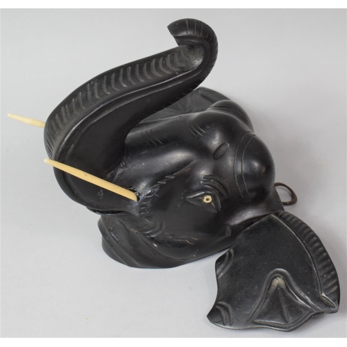 116 - A Carved Ebony Wall Hanging Elephant Head with Trunk in Salute, 19cm High