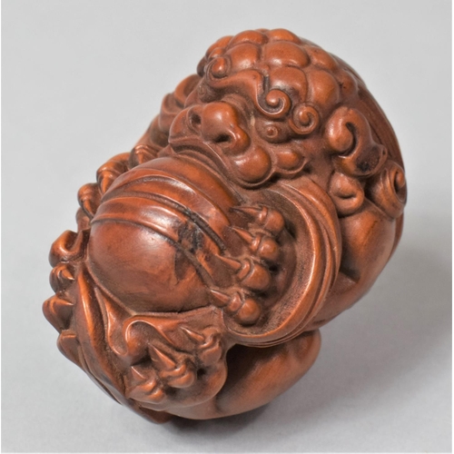 266 - A Nicely Carved Hardwood Temple Lion Ball, 6cm High