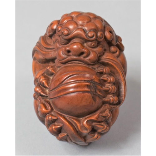 266 - A Nicely Carved Hardwood Temple Lion Ball, 6cm High