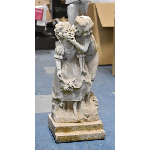 449 - A Small Reconstituted Stone Garden Figural Ornament Depicting Boy and Girl Kissing, 41cms High