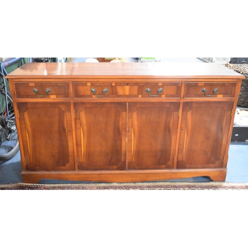 491 - A Modern Crossbanded Yew Wood Sideboard with Three Drawers over Cupboard Base, 150cms Long