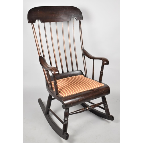 503 - A Mid 20th century Spindle Back Rocking Chair with Upholstered Padded Seat