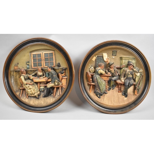 180 - A Pair of Continental Circular Relief Wall Hangings Depicting Interior Scenes, 33cm diameter