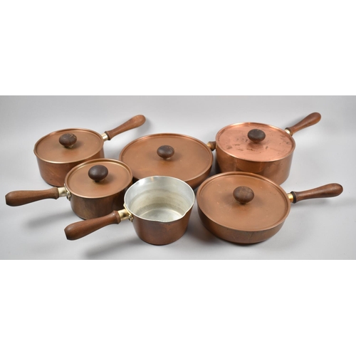 111 - A Collection of Six Copper Cooking Pans with Turned Wooden Handles,