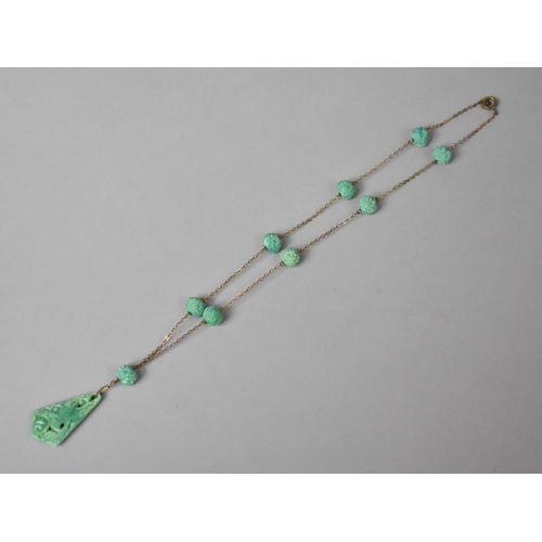 240 - An Oriental Carved Green Stone Necklace