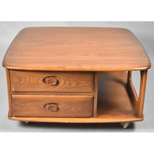 576 - An Ercol Mid Century Pandora Coffee Table, Model No.375 in Elm, with Two Side Drawers on Ball Caster... 