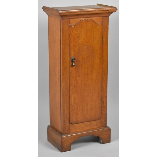 62 - A Mid 20th Century Oak Narrow Shelved Cabinet, 33cm wide and 74cm high