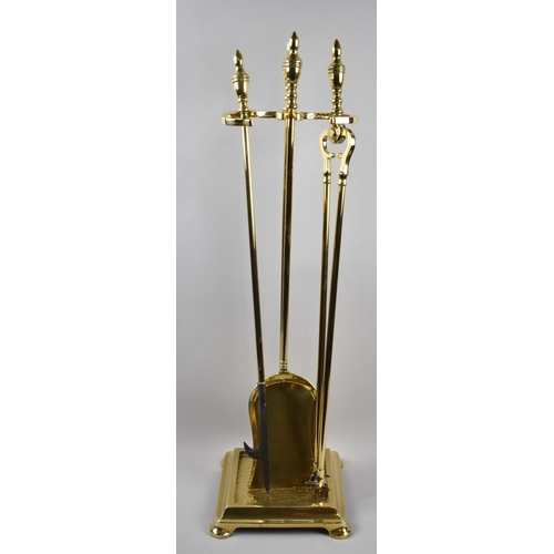 63 - A Good Quality Brass Fire Companion Set with Long Handled Fire Irons on Square Base and Bun Feet, 22... 