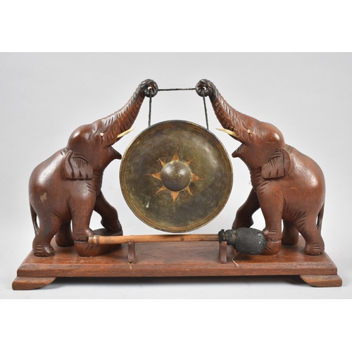 72 - A Carved Wooden Indian Souvenir Gong on Stand, Supports in the Form of Elephants, Plinth Base with C... 