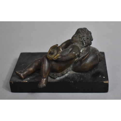 3 - A Bronze Metal Study of a Reclining Cherub on Cushion with Flower in Hand Mounted on Rectangular Bas... 