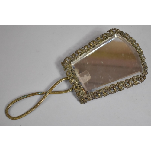 46 - An Early 20th Century Ornately Framed Brass Bevel Edged Folding Hand Mirror with Pierced Decoration,... 