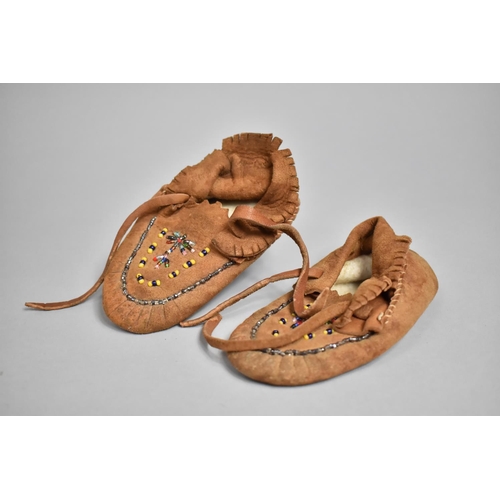 573 - A Pair of Suede Moccasin Shoes with Beaded Decoration