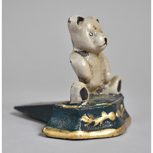 575 - A Cast Metal Painted Doorstop with Teddybear Decoration together with a Metal and Blue Glass Perfume... 