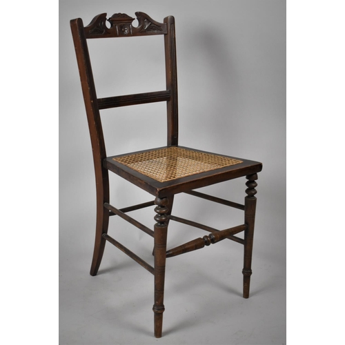 577 - A Side Chair with Swan Cornice Top, and Carved Decoration and Cane Seat