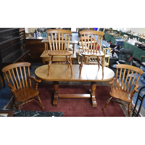 517 - An Extending Oval Oak Dining Table with One Extra Leaf, Together with Four Dining Chairs to Include ... 