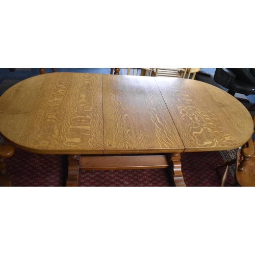 517 - An Extending Oval Oak Dining Table with One Extra Leaf, Together with Four Dining Chairs to Include ... 