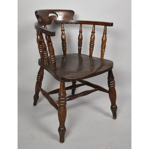 521 - A Vintage Oak Smokers Bow Spindle Back Armchair