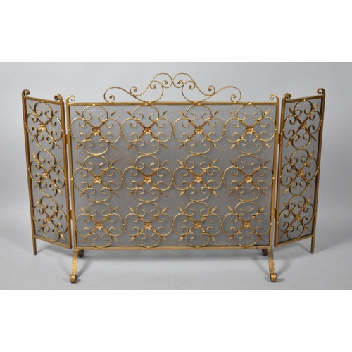 542 - A Gilt Painted Wrought Iron Three Fold Fire Screen on Scrolled Supports, Centre Section 79cm wide