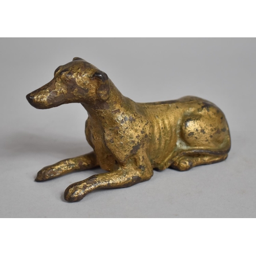 84 - An Early 19th Century Cast Iron recumbent Greyhound with Gilt Decoration. 14cms Long