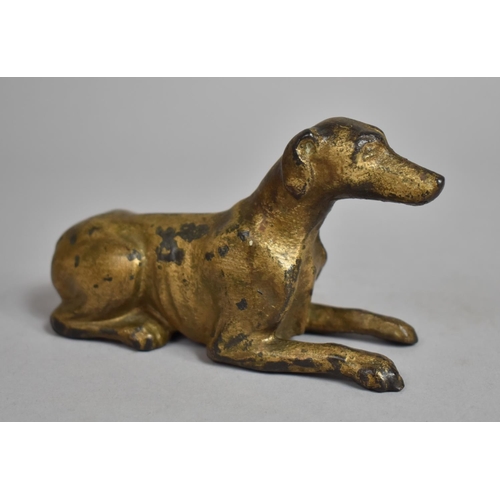 84 - An Early 19th Century Cast Iron recumbent Greyhound with Gilt Decoration. 14cms Long