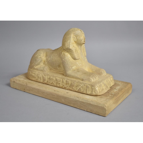 31 - A 19th Century Plaster Figure of a Sphinx Sitting on a Plinth Decorated with Hieroglyphs, Mounted on... 