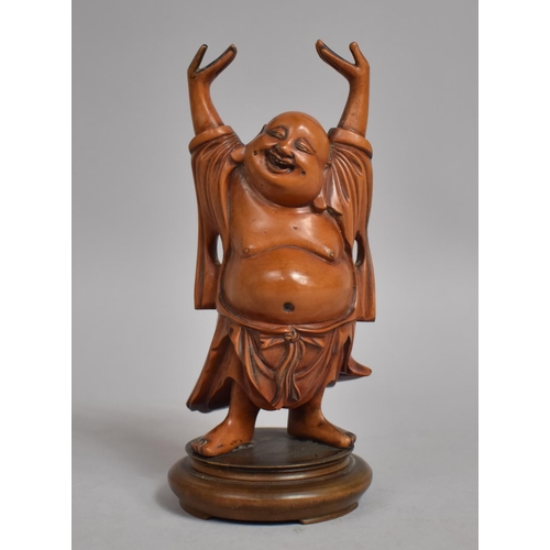 65 - A 19th Century Chinese Carved Boxwood Figure of a Buddha with his Arms Aloft on a Turned Wooden Stan... 