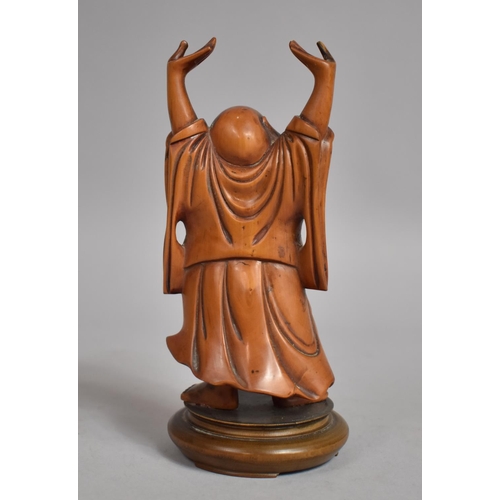 65 - A 19th Century Chinese Carved Boxwood Figure of a Buddha with his Arms Aloft on a Turned Wooden Stan... 