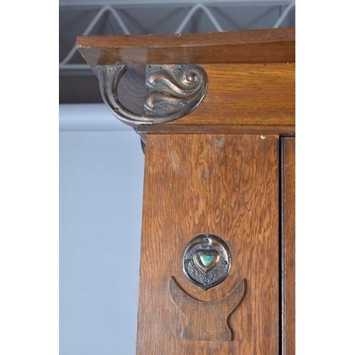 436 - An Arts and Crafts Oak Single Wardrobe with Mirror Front and Having Pressed Copper Rosettes and Hear... 