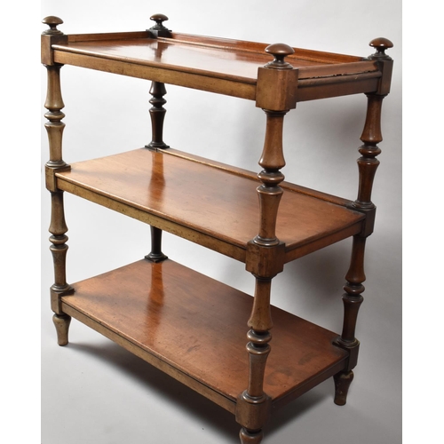 7 - A Victorian Mahogany Three Tier Buffet with Galleried Top Shelf and Turned Supports. 86x46x102cms Hi... 