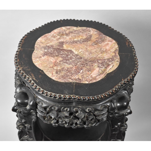 122 - A Carved Chinese Circular Hardwood Vase Stand with Marble Top, Stretcher Shelf and Claw and Ball Fee... 