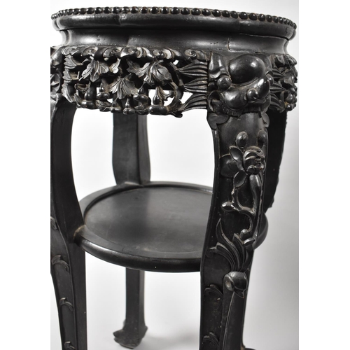 122 - A Carved Chinese Circular Hardwood Vase Stand with Marble Top, Stretcher Shelf and Claw and Ball Fee... 