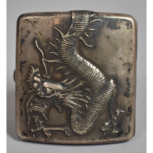 128 - A Chinese White Metal Cigarette Case Decorated in relief with Snarling Dragon. 93.8cms