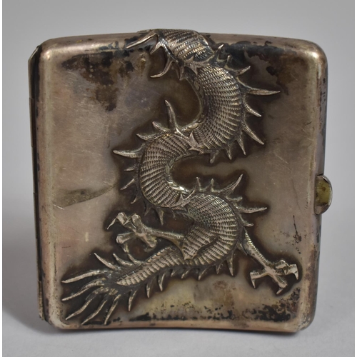 128 - A Chinese White Metal Cigarette Case Decorated in relief with Snarling Dragon. 93.8cms