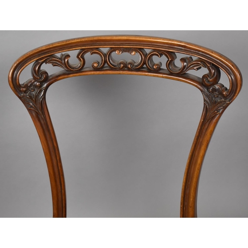 438 - A Pair of Late Victorian Mahogany Framed Nursing Chairs having Balloon Backs with Carved and Pierced... 