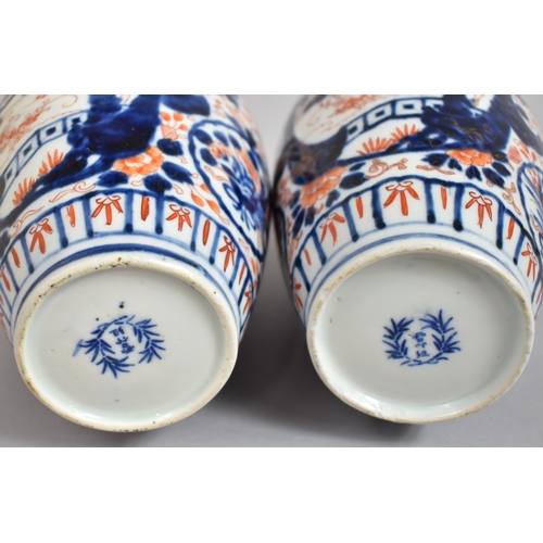 382 - A Pair of Early 20th Century Japanese Imari Vases with Clobbered Decoration. 25cms High