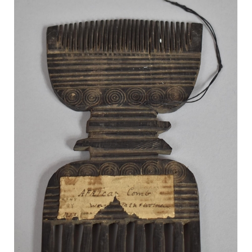 132 - A 19th Century African Tribal Comb with Roudel Design having Paper Label. 24.5cms Long