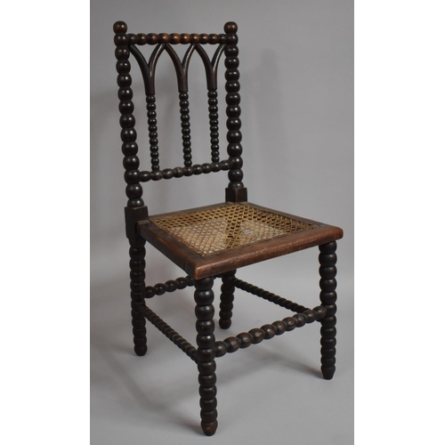 68 - A Late 19th/Early 20th Century Bobbin Framed Childs Chair with Cane Seat. 65.5cms High