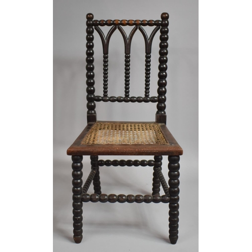 68 - A Late 19th/Early 20th Century Bobbin Framed Childs Chair with Cane Seat. 65.5cms High