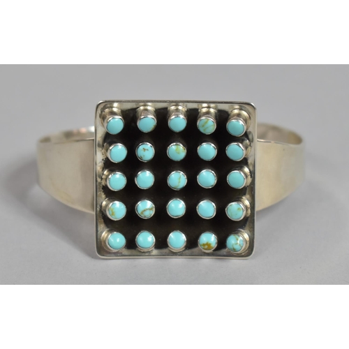 175 - A Heavy Silver and Turquoise Cuff Bracelet, Navajo Style, with Large Central Concave Square Shaped E... 