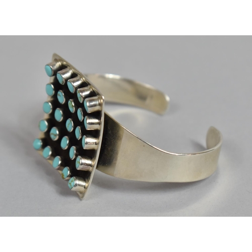 175 - A Heavy Silver and Turquoise Cuff Bracelet, Navajo Style, with Large Central Concave Square Shaped E... 