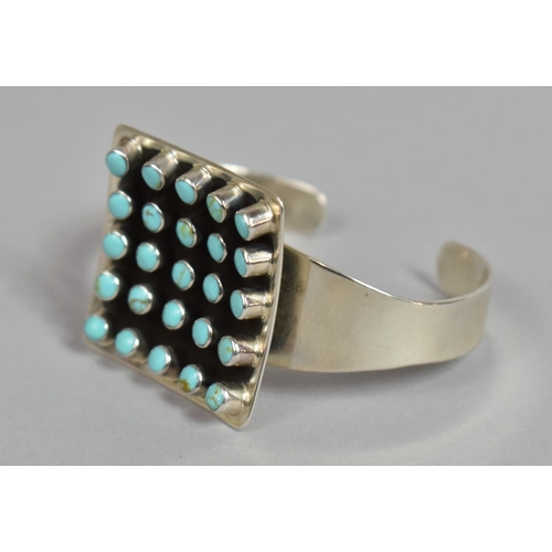 175 - A Heavy Silver and Turquoise Cuff Bracelet, Navajo Style, with Large Central Concave Square Shaped E... 