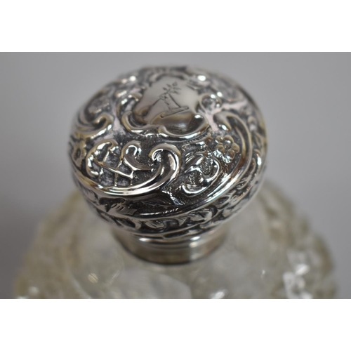 242 - A Silver Topped Globular Perfume Bottle with Inner Stopper, 11cms High